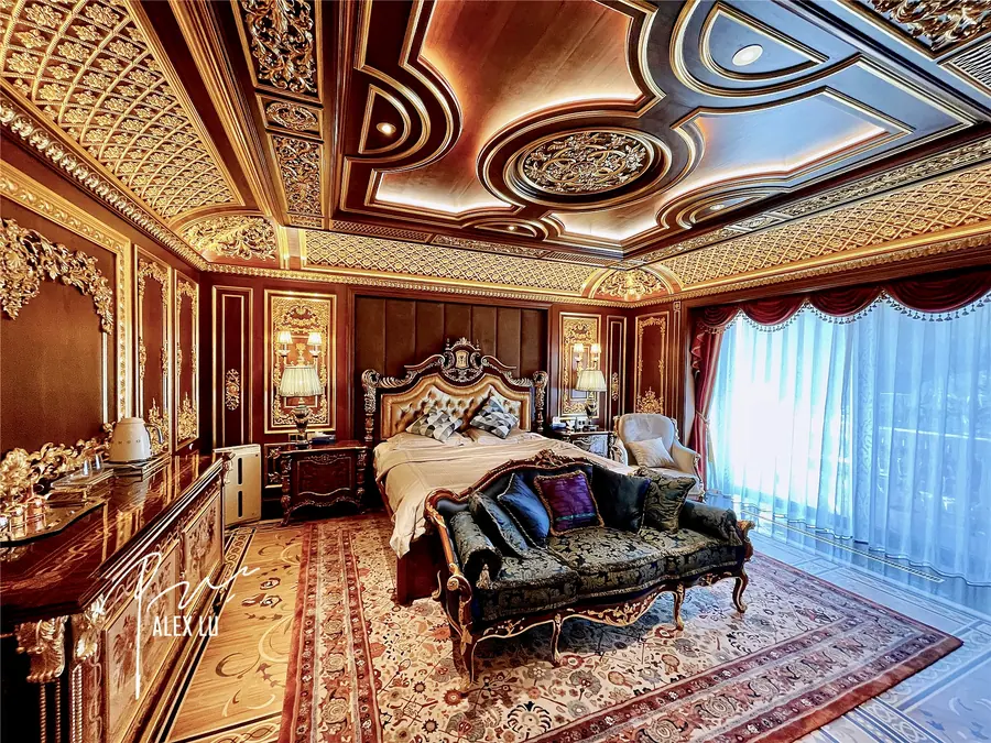 Classical bedroom with ornate ceiling and warm lighting