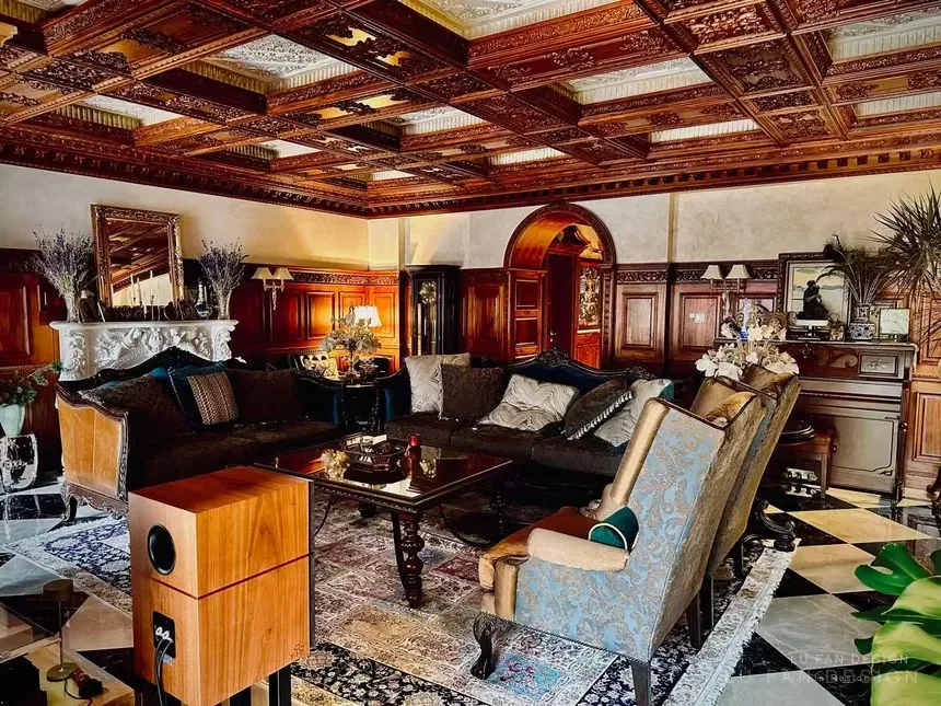 Wide living room view with carved wood ceiling