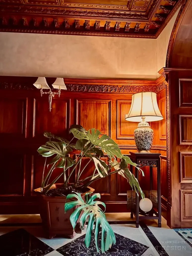 Wood panel wall with plant and warm table lamp